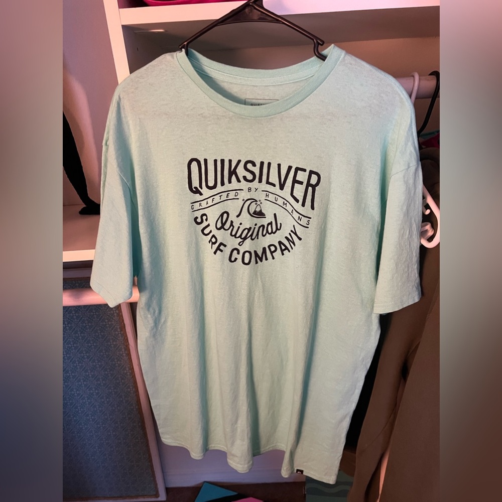 Blue/green looking shirt, second picture is more accurate for color